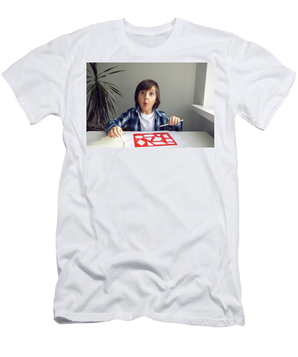 1 Boy Child Draws on Paper with a Ruler on a Table Sitting By the Window Elena Saulich T-Shirt
