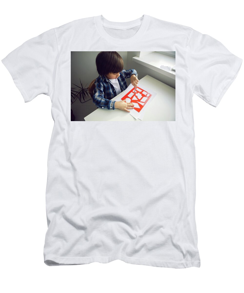 6 Boy Child Draws on Paper with a Ruler on a Table Sitting By the Window Elena Saulich T-Shirt
