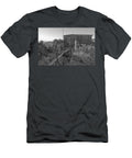 A Pair of Old Metal Rusting Carriage Wheels Seen Parked Behind a Stone Wall Jules Walters T-Shirt