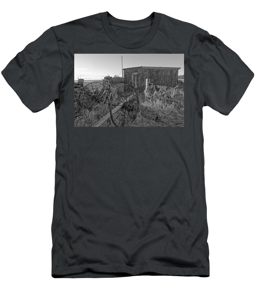 A Pair of Old Metal Rusting Carriage Wheels Seen Parked Behind a Stone Wall Jules Walters T-Shirt