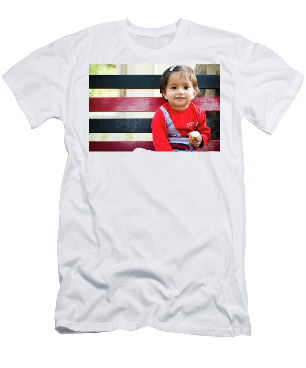 Little Girl Sitting on a Bench and Eating an Ice Cream Cone Shilpa Panchal T-Shirt
