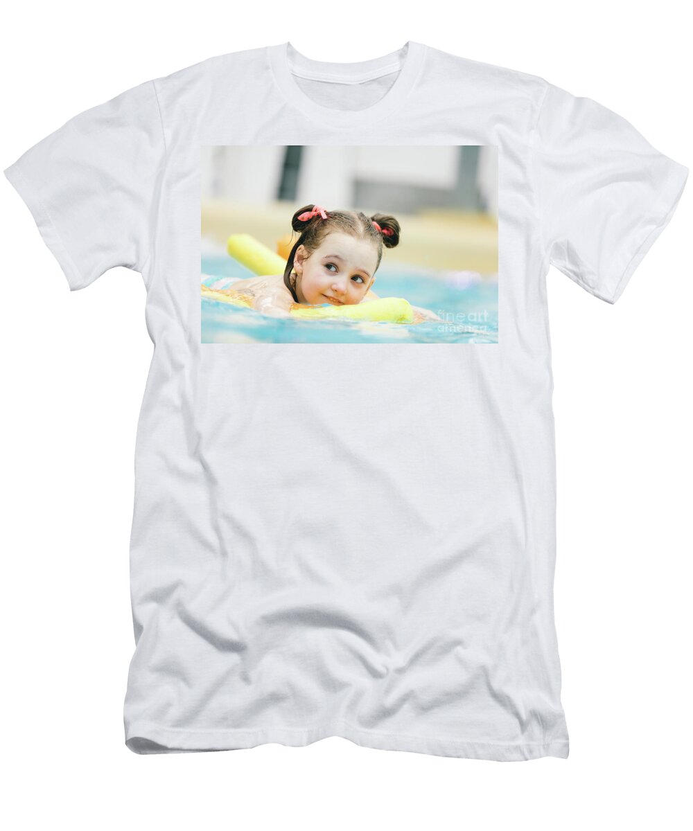 Little Girl Swimming with a Yellow Noodle in a Pool Michal Bednarek T-Shirt