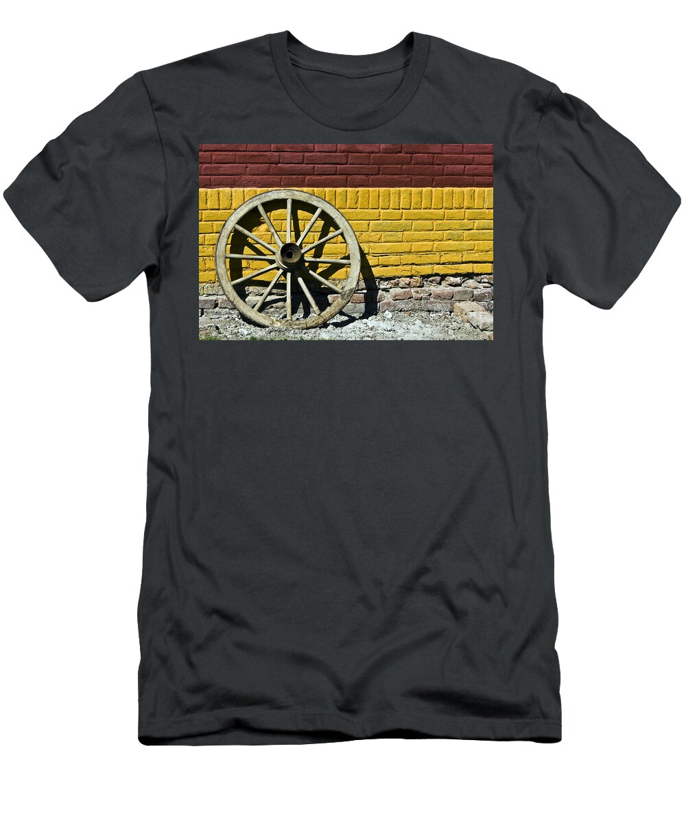 Old Wooden Wheel Against a Wall Dan Radi T-Shirt