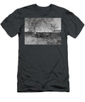 The Bare Chassis of a Four Wheel Trailer Lies Abandoned in a Corner of a Field Jules Walters T-Shirt