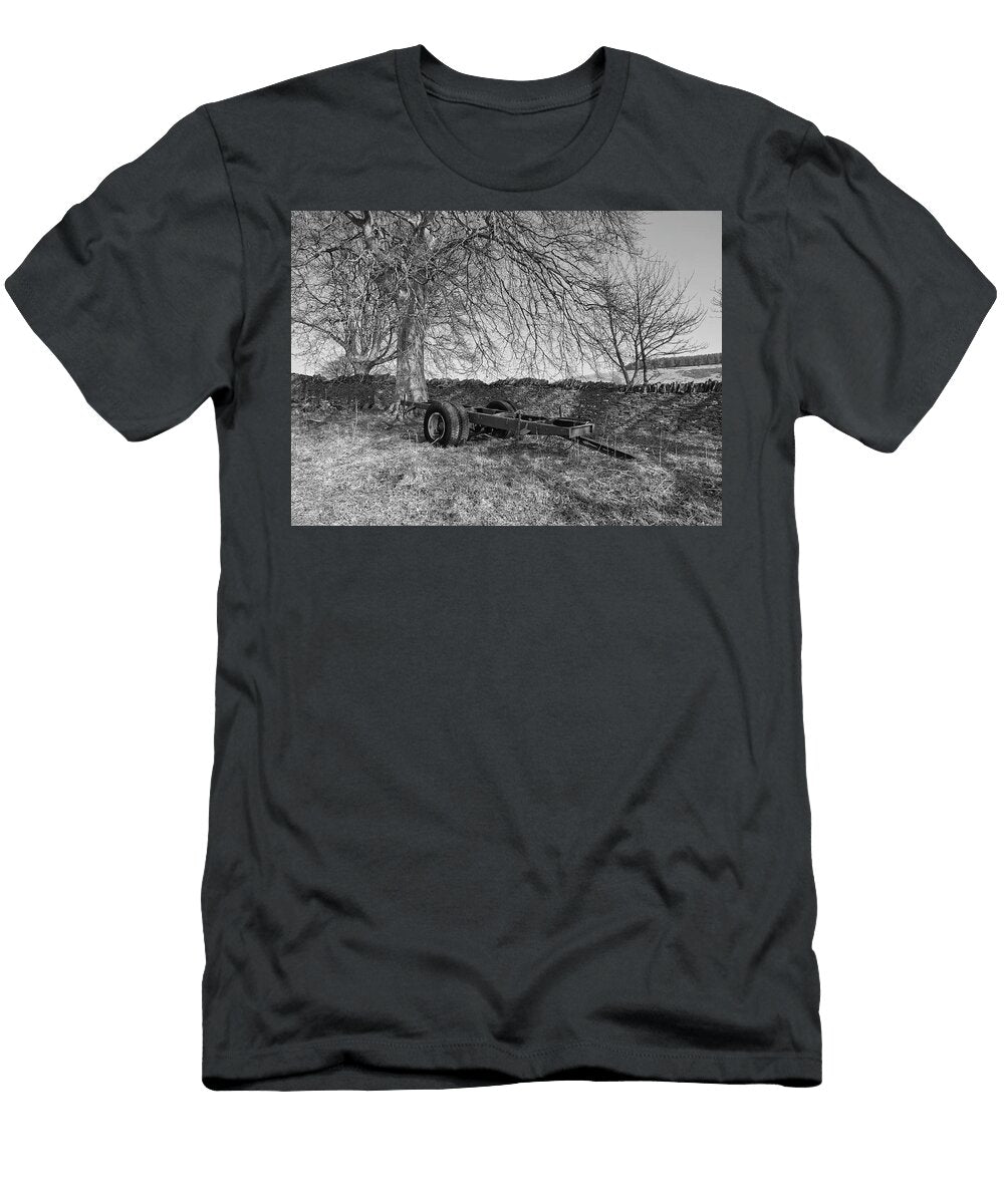 The Bare Chassis of a Four Wheel Trailer Lies Abandoned in a Corner of a Field Jules Walters T-Shirt